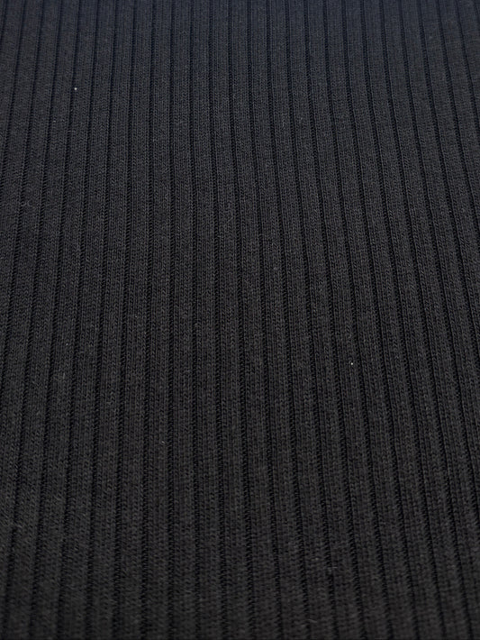 A close-up of a black ribbed knit fabric